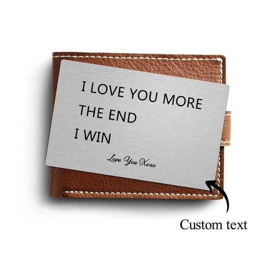 Close-up of a personalised 'I Love You More' engraved metal wallet card in silver — a discreet, rust‑resistant keepsake wallet insert and anniversary gift for him