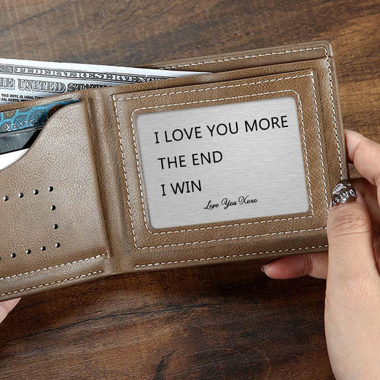 Close-up of a personalised 'I Love You More' engraved metal wallet card in silver — a discreet, rust‑resistant keepsake wallet insert and anniversary gift for him