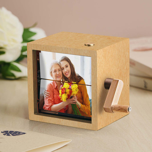 Compact personalised eight-photo music flipbook frame on a white background, featuring a hand-crank and integrated lighting for eight customised photos.