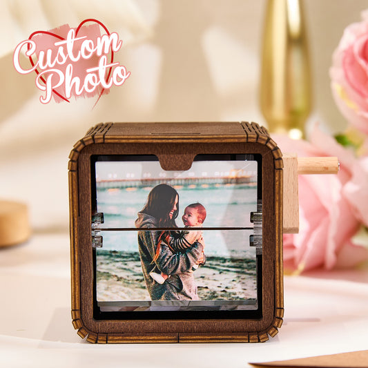 Custom hand-crank flipbook frame displaying 16 personalised photos with LED lighting and built-in music animation