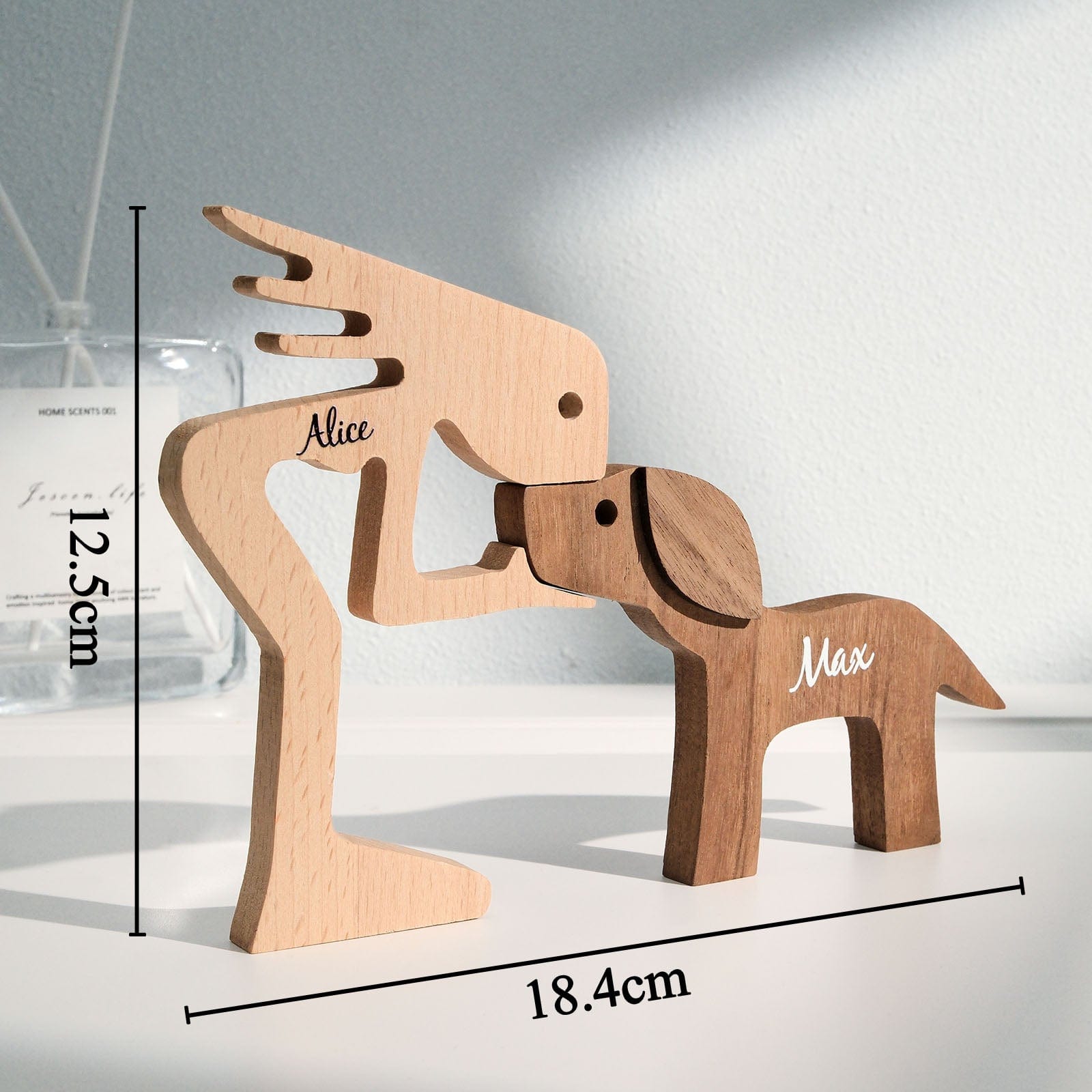 Personalised wooden pet carving block displayed on a desk with stationery — bespoke engraved name table decor for home or office