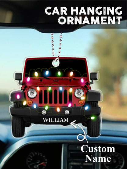 Lifestyle image of personalised car Christmas ornament hanging on a decorated tree, engraved name catching the light on clear acrylic