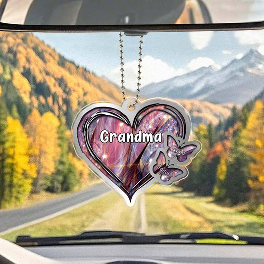 Close-up of personalised Heart and Butterfly Car Ornament showing engraving on clear acrylic.