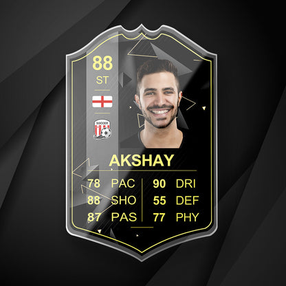 Angled view of S22 Gold Inform personalised football card in acrylic displaying player stats, country flag and grading score — personalised football present