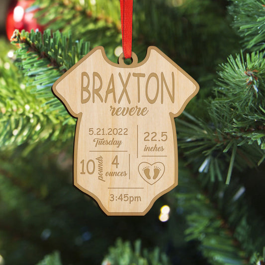 Personalised baby birth ornament — engraved wooden bauble with name and birth details hanging on a Christmas tree, a timeless wooden first Christmas keepsake and custom birth stats decoration