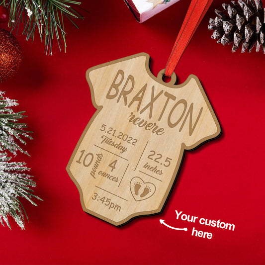 Personalised baby birth ornament — engraved wooden bauble with name and birth details hanging on a Christmas tree, a timeless wooden first Christmas keepsake and custom birth stats decoration