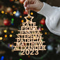 Collection of family name personalised Christmas tree ornaments displayed on a tree, bespoke wooden keepsakes and custom name decorations for generations
