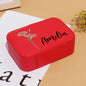 Top-down view of multi-compartment layout with cushioned ring rolls, earring slots and necklace hooks in personalised box