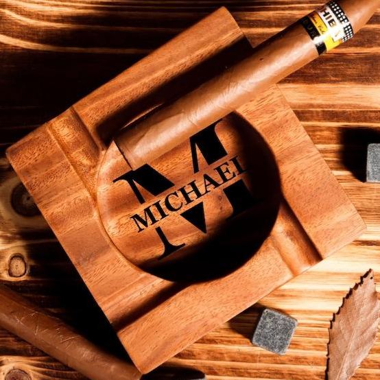 Personalised walnut cigar ashtray side view showing single-cut carved base and deep-set cigar grooves, engraved wooden cigar rest