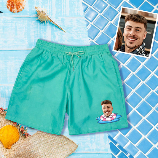 Personalised colour-changing swim trunks with customised face on green-to-blue gradient, front view – fast-drying polyester beach shorts