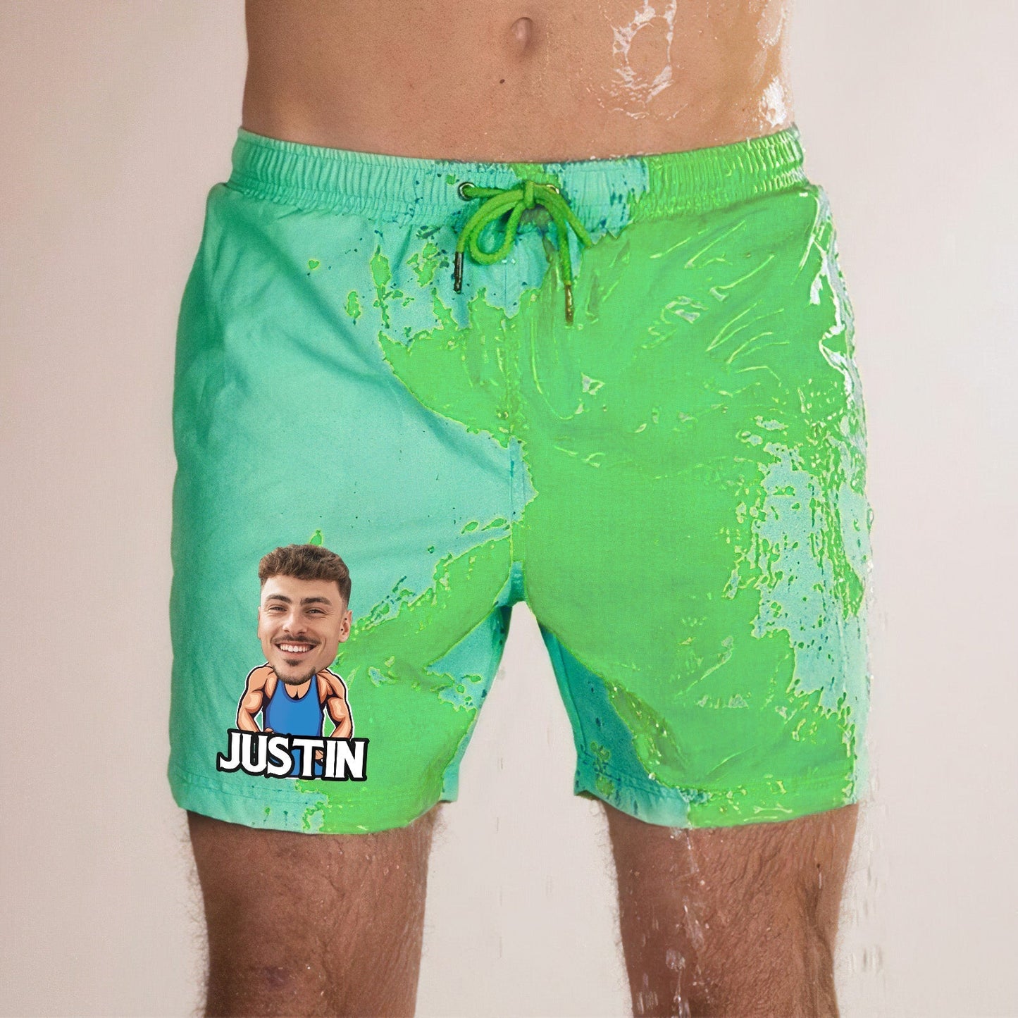 Personalised colour-changing beach shorts in green-to-blue gradient with customised face and name print on fast-drying polyester, thermochromic swim trunks