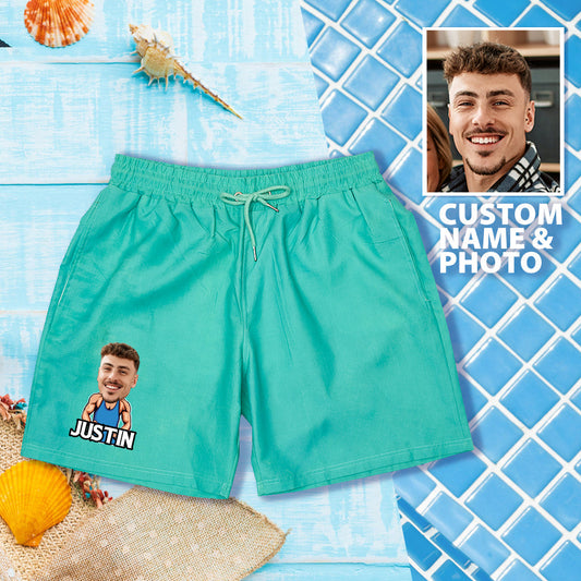 Personalised colour-changing beach shorts in green-to-blue gradient with customised face and name print on fast-drying polyester, thermochromic swim trunks