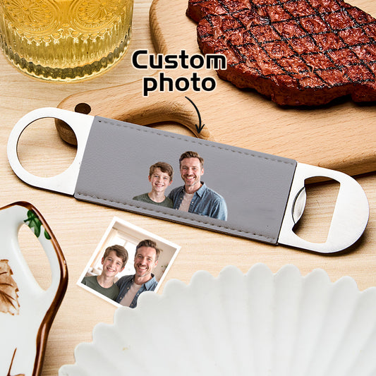 Personalised photo bottle opener featuring a printed photograph on a premium PU leather handle and a robust metal opener, ideal as a wedding favour or groomsmen gift.