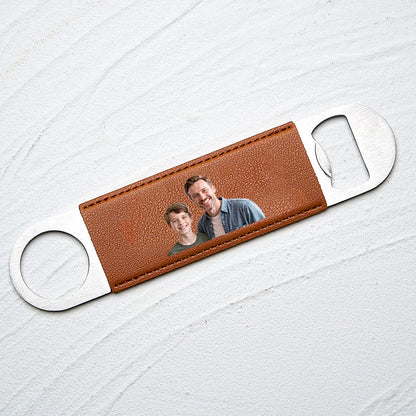 Close-up shot of the printed photo on the leather handle with metal opener.