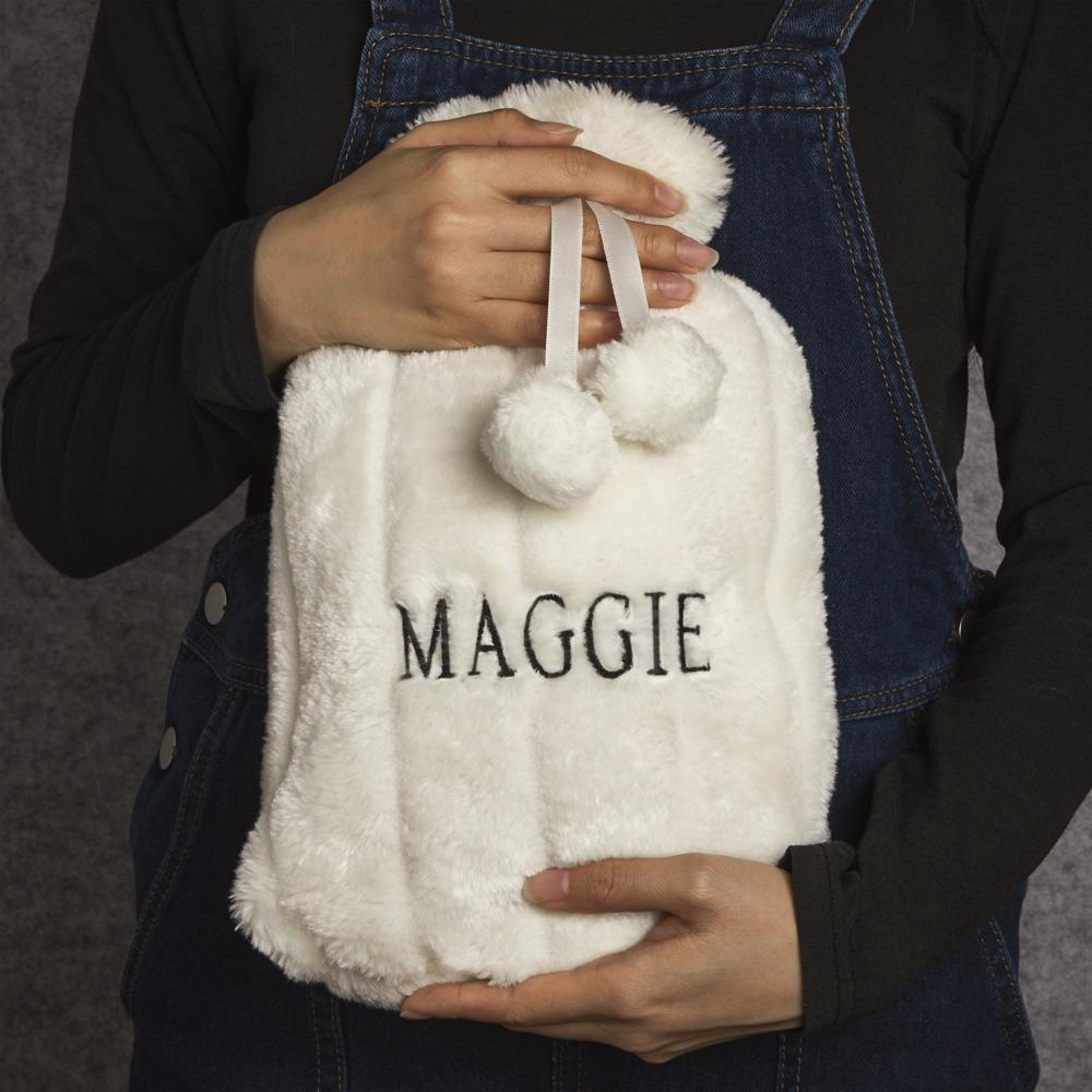 Angled view showing embroidered name detail on plush hot water bottle cover, high-quality stitching for a personalised present