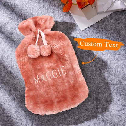 Close-up of plush cover fabric and embroidered lettering on a personalised hot water bottle, showing removable washable cover