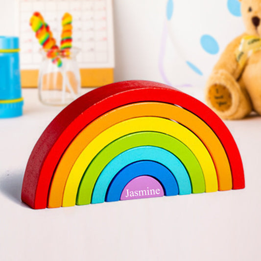 Handmade wooden rainbow stacker in earth colours, fully stacked as a Montessori nesting puzzle and wooden stacking toy