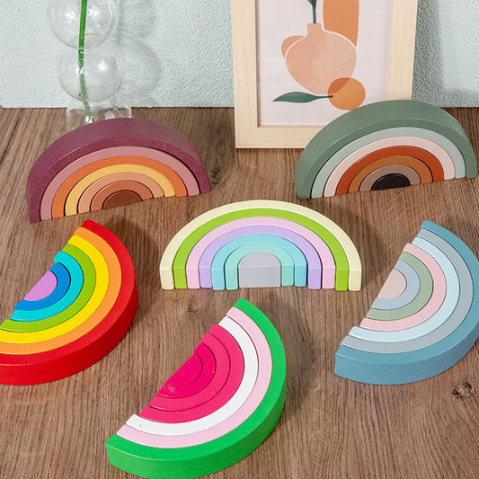 Handmade wooden rainbow stacker in earth colours, fully stacked as a Montessori nesting puzzle and wooden stacking toy