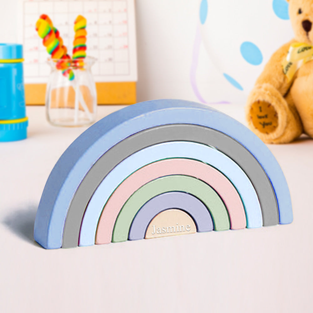 Multi-piece wooden rainbow stacker used as creative props for counting, colour-sorting and storytelling in a Montessori playroom