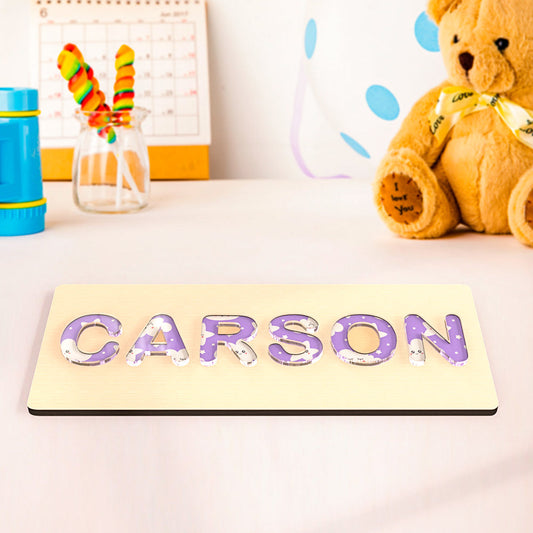 Personalised name puzzle with colourful acrylic letters on a smooth wooden base — custom Montessori baby gift