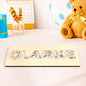 Individual letter pieces removed from the wooden base demonstrating puzzle fit and fine motor skill development
