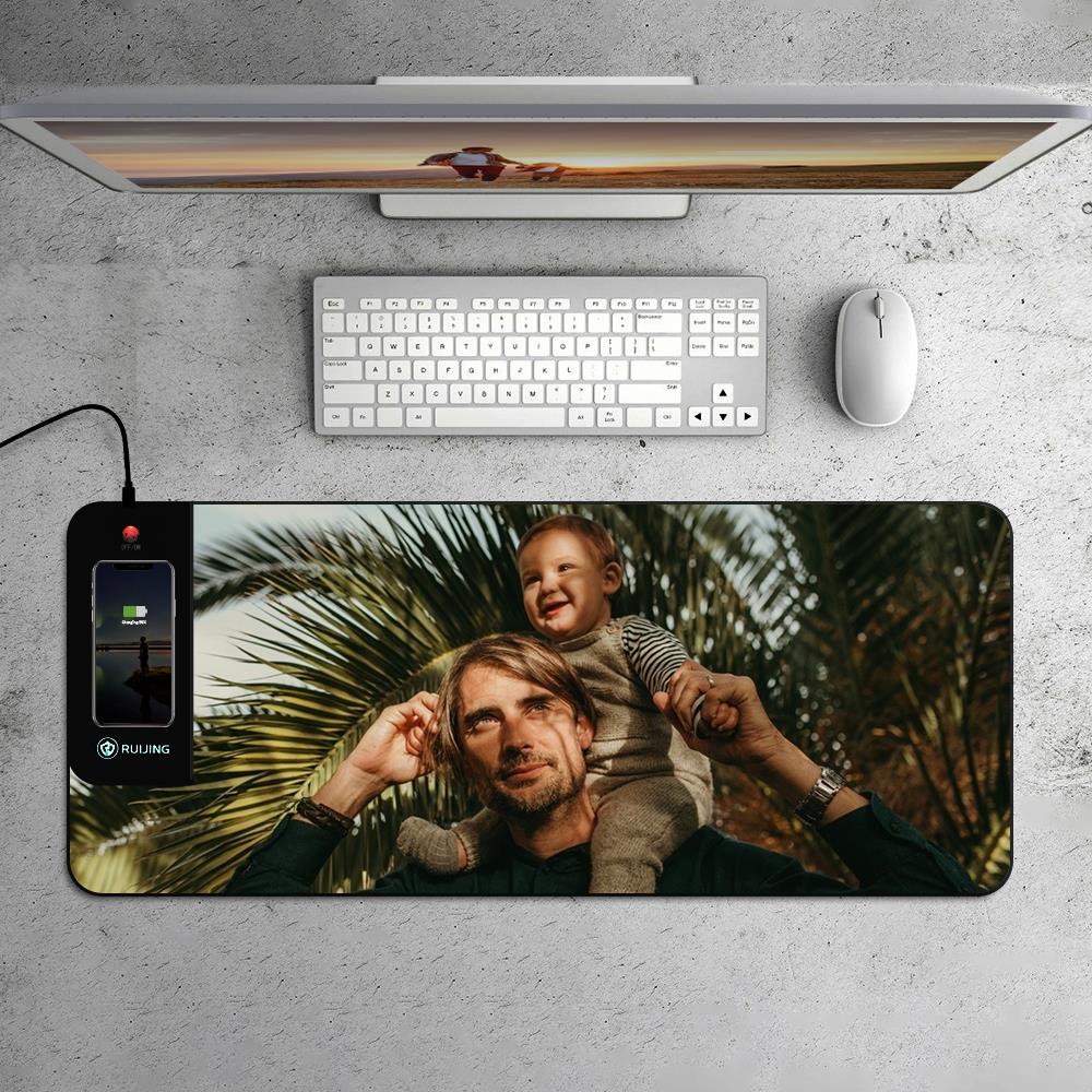 Detail of integrated Qi wireless charging area on personalised LED mouse mat with a smartphone placed on the charging zone