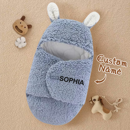 Front view of hooded bunny-ear swaddle on a neutral background.