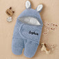 Hood with bunny ears feature accent on the swaddle.