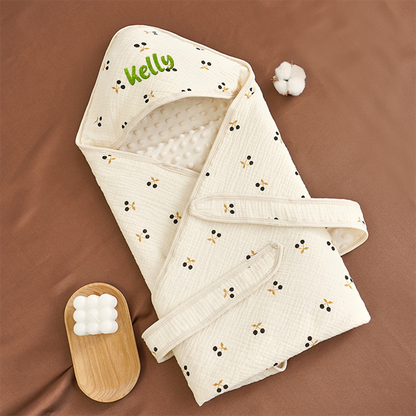 Soft cotton swaddle blanket folded for display, showing material and embroidery