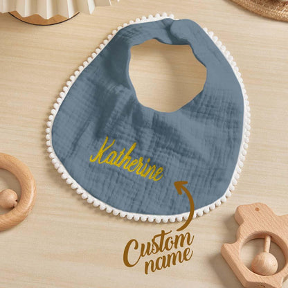 Stack of personalised embroidered baby bibs showing colourways and cotton texture — ideal personalised baby gift set