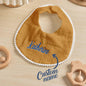 Close-up of soft cotton fabric and durable embroidered lettering on a personalised baby bib — maintains quality after washes