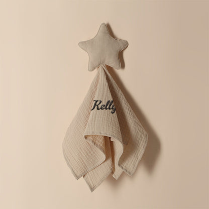 Stack of personalised baby towels in different shades showing star pattern and embroidered name options, premium cotton baby gifts