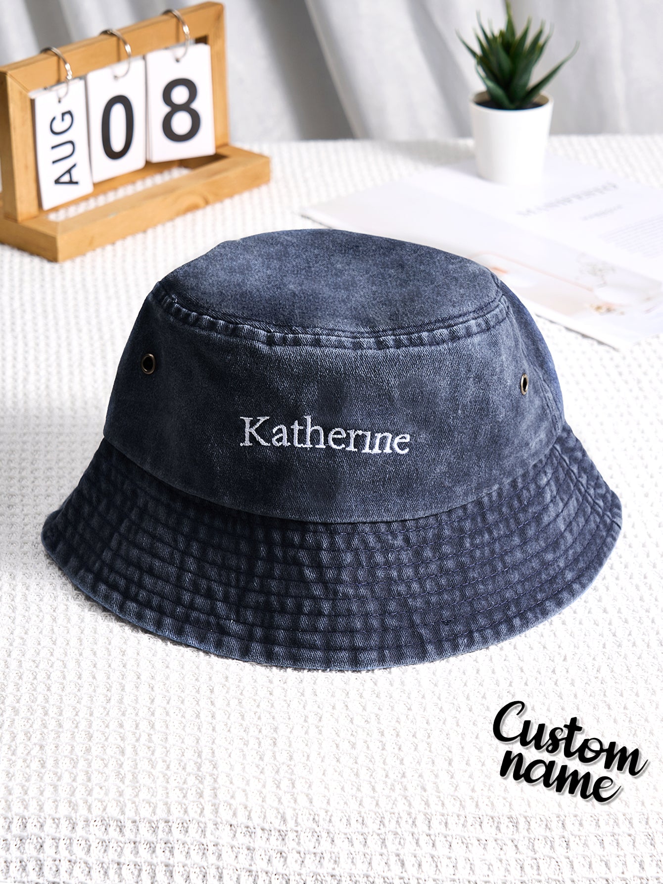 Flat-lay of personalised denim bucket hat with custom name embroidery — stylish personalised gift for Mother's Day, graduation or birthdays