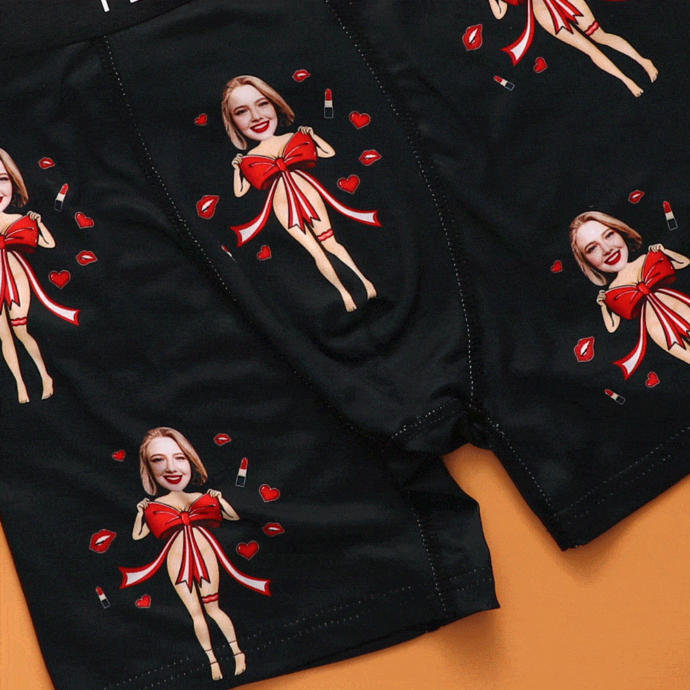 Close-up of black personalised photo boxers showing red bow, soft elastic waistband and printed custom face
