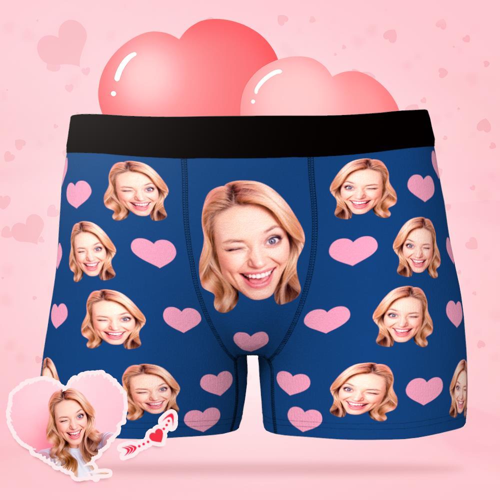 Product flat-lay of personalised men's boxer briefs with custom photo and tiny heart emblem, available in multiple colours and sizes and ideal as a personalised gift