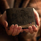 Close-up of custom photo engraving on classic leather wallet showing fine detail and permanent engraving finish