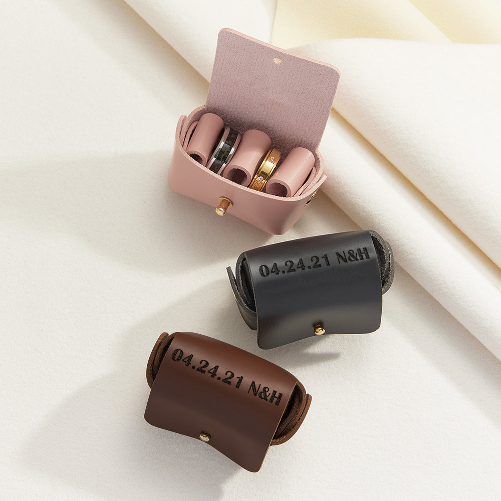 Close‑up of hand‑stamped personalised engraving and natural leather grain on a handcrafted wedding ring pouch — ideal engraved ring box or jewellery storage