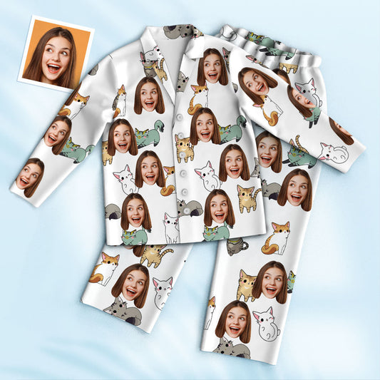 Styled set of personalised cartoon cat pyjamas showing bespoke face cutout on top and matching pyjama bottoms, handcrafted unisex sleepwear.