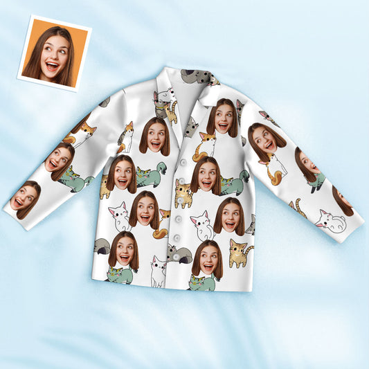 Styled set of personalised cartoon cat pyjamas showing bespoke face cutout on top and matching pyjama bottoms, handcrafted unisex sleepwear.