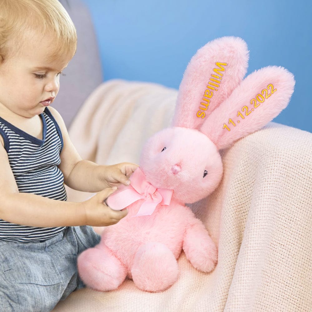 Side view of the soft bunny plush, showcasing its relaxed body pose.