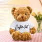 Lifestyle image of personalised teddy bear placed on a bed — custom 30cm plush makes an unforgettable birthday or graduation present