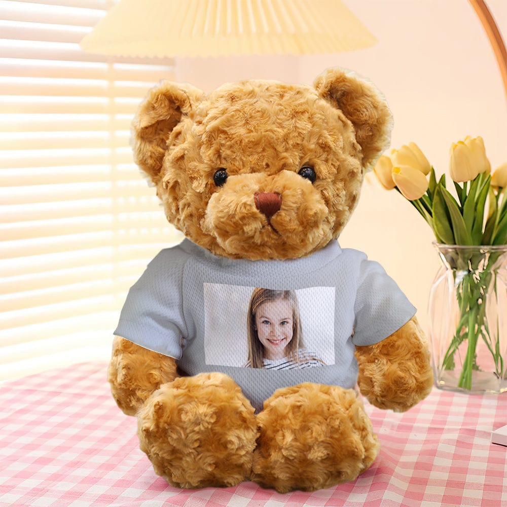 Personalised teddy bear with removable clothes laid out to highlight care instructions – spot clean and hand-wash details