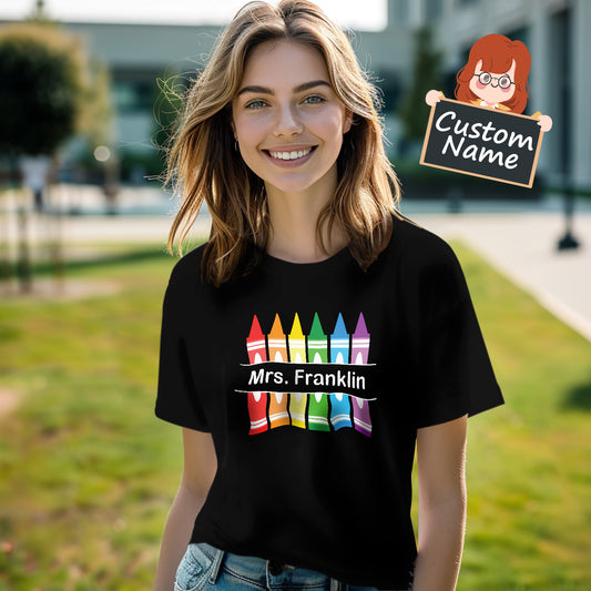 Personalised Crayon Teacher T-Shirt front view showing colourful crayon design with space for a custom name – soft polyester Back to School teacher gift (AU & UK)