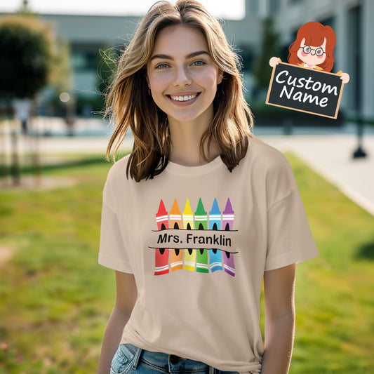 Personalised Crayon Teacher T-Shirt front view showing colourful crayon design with space for a custom name – soft polyester Back to School teacher gift (AU & UK)