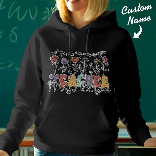 Personalised wildflower hooded sweatshirt shown from the back with floral artwork and custom name — perfect personalised teacher gift and custom name hoodie for back-to-school