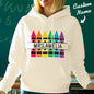 Close-up of crayon-themed graphic and printed custom name on personalised hooded sweatshirt — vibrant colours for a thoughtful teacher gift