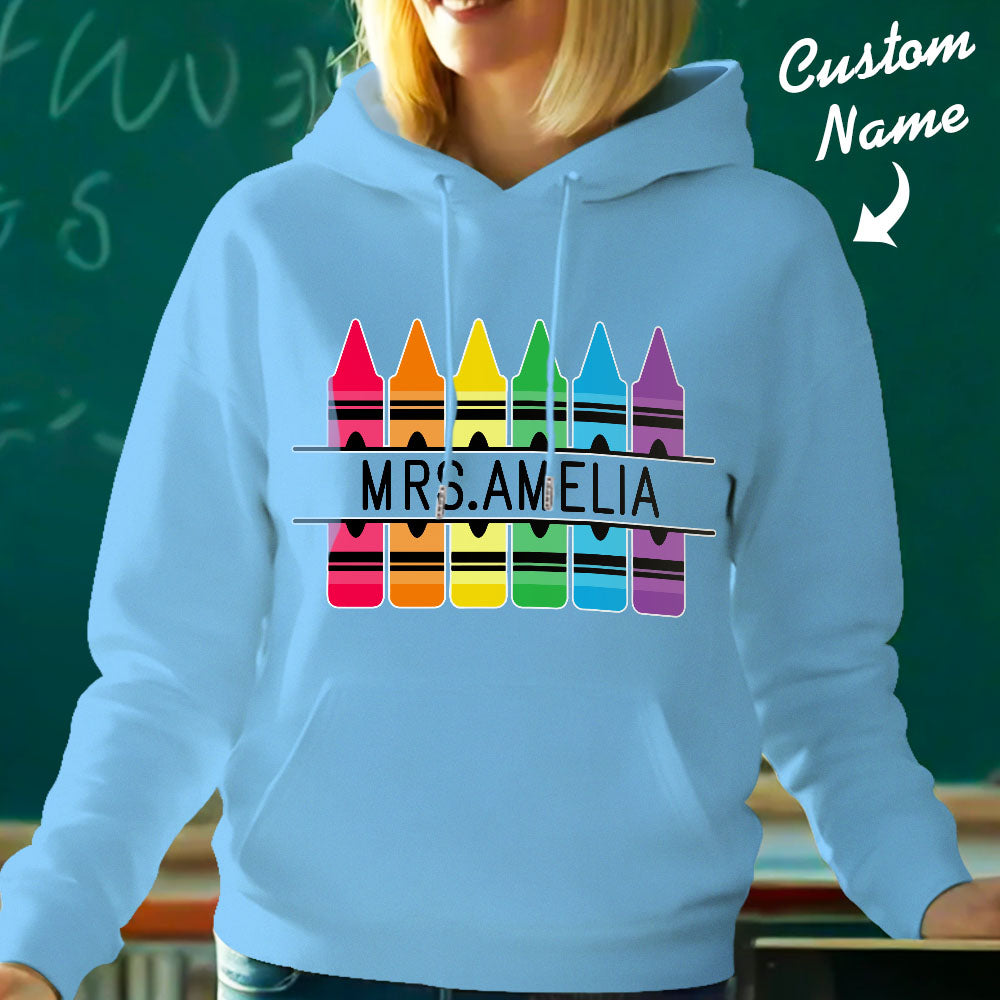 Personalised crayon hooded sweatshirt neatly folded and presented — ideal custom-name teacher gift or birthday present for school staff