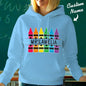 Personalised crayon hooded sweatshirt neatly folded and presented — ideal custom-name teacher gift or birthday present for school staff