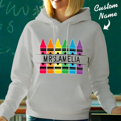 Detail shot of the printed custom name and crayon illustration on the personalised hooded sweatshirt — high-quality print for teacher gifts