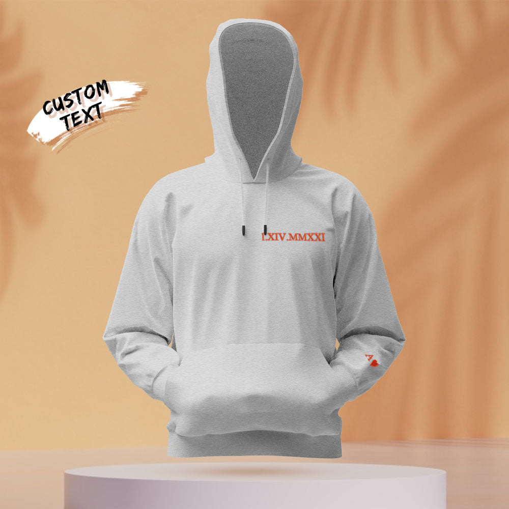 Styled photo of embroidered couples hoodie — personalised Roman numeral date, ideal Valentine’s gift